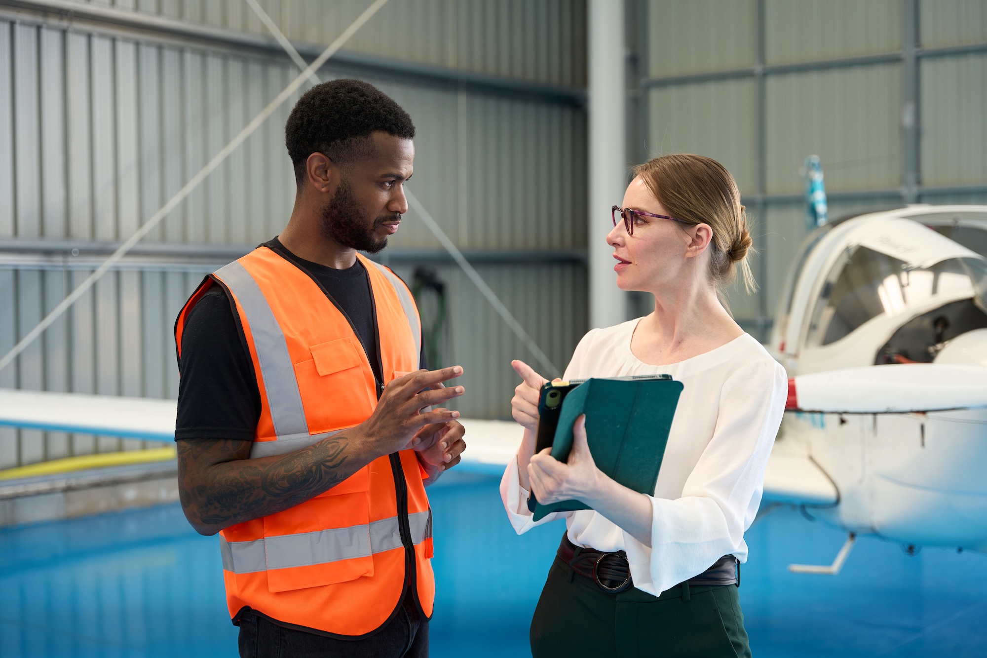 Aircraft maintenance instructor guiding student in hangar